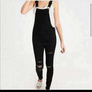 Black distressed jegging overalls